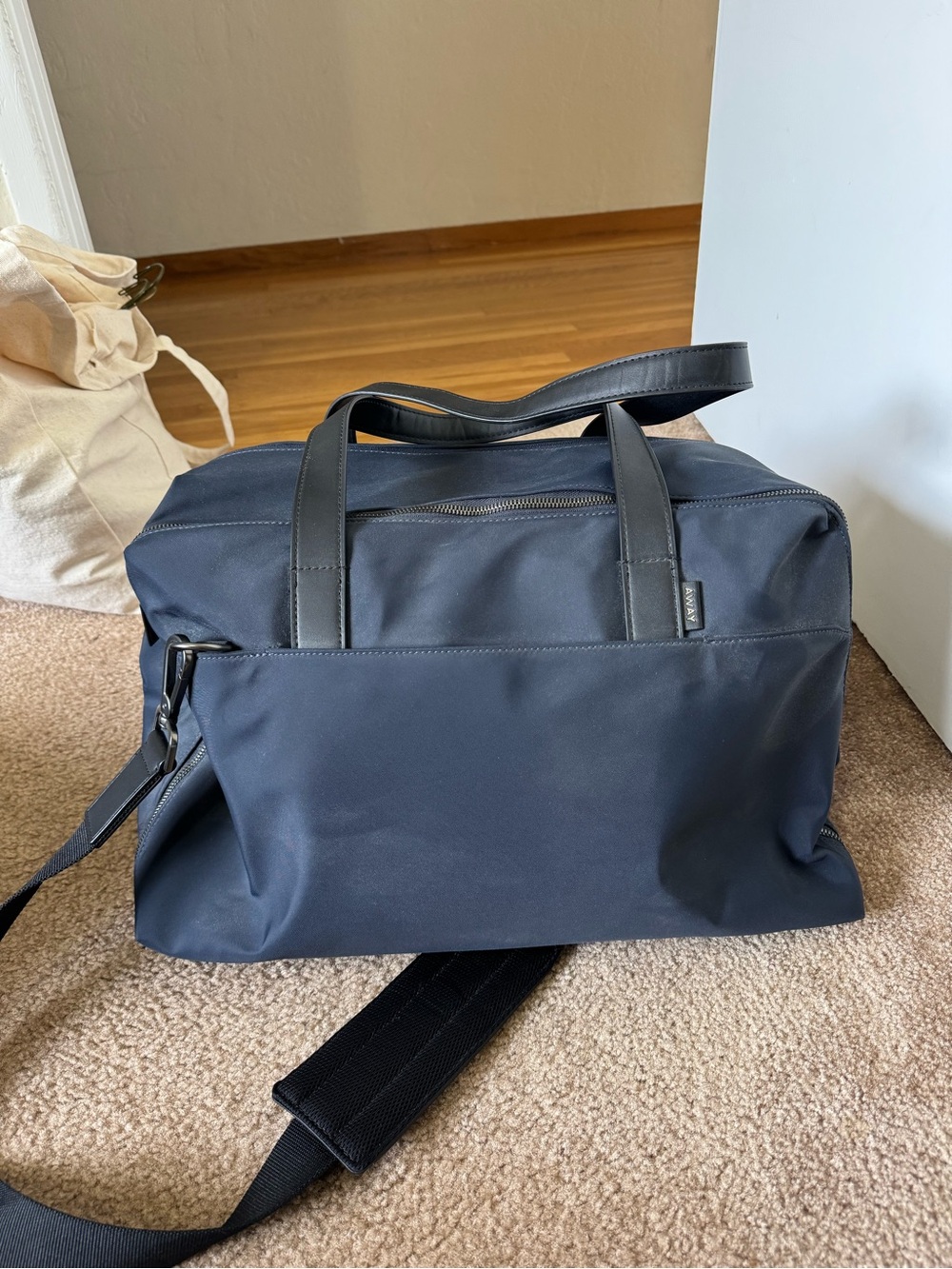Away Navy Travel Weekender Bag with Black Handles